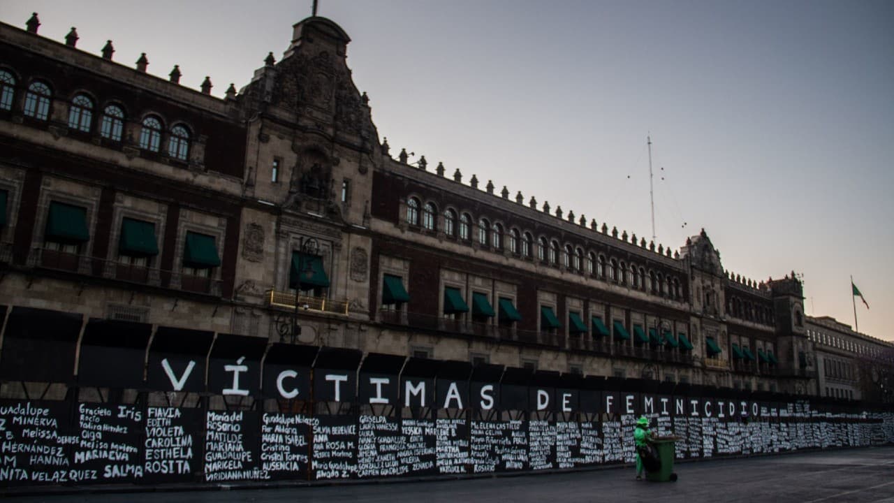 Mujeres pintan valla de Palacio Nacional con nombres de víctimas de feminicidio